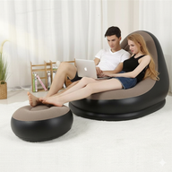 Two people using a modern inflatable sofa and ottoman in a living room setting.